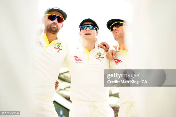 Steve Smith captain of Australia alongside Nathan Lyon and David Warner talks to players in a huddle prior to play during day one of the First Test...