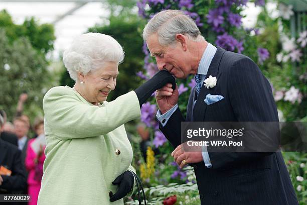 Queen Elizabeth II presents Prince Charles, Prince of Wales with the Royal Horticultural Society's Victoria Medal of Honour during a visit to the...