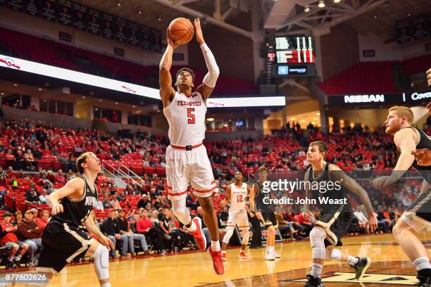 Justin Gray of the Texas Tech Red Raiders goes to the basket and will score during the first half of the game between the Texas Tech Red Raiders and...