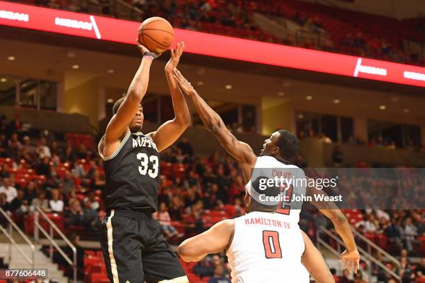 Cameron Jackson of the Wofford Terriers shoots the ball over Keenan Evans of the Texas Tech Red Raiders during the first half of the game between the...