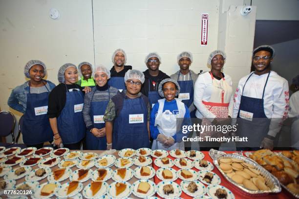 Tai Davis, Barton Fitzpatrick, Common, and Shamon Brown Jr. Volunteer at St Stephen AME Church in partnership with Feeding America, The Common Ground...