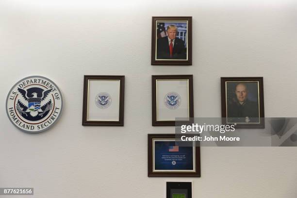 Portrait of U.S. President Donald Trump hangs over empty frames at the U.S. Border Patrol office on November 22, 2017 in Van Horn, Texas. Key...