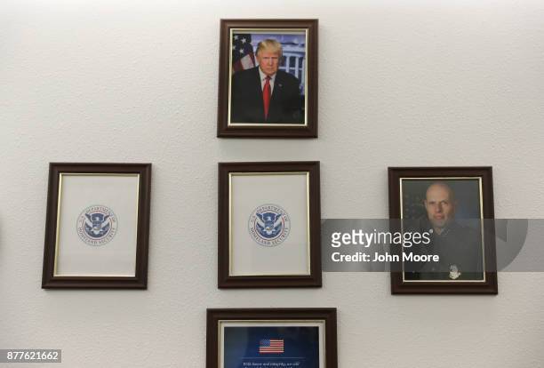 Portrait of U.S. President Donald Trump hangs over empty frames at the U.S. Border Patrol office on November 22, 2017 in Van Horn, Texas. Key...