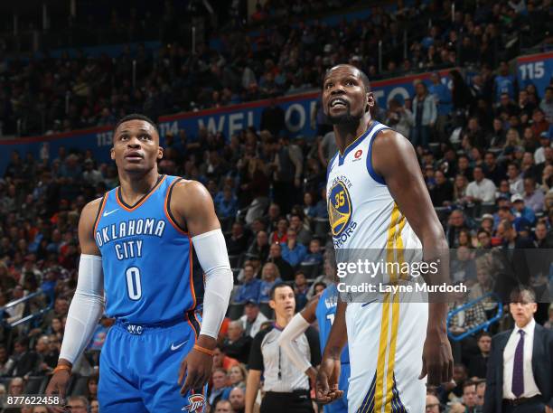 Kevin Durant of the Golden State Warriors and Russell Westbrook of the Oklahoma City Thunder looks on on November 22, 2017 at Chesapeake Energy Arena...