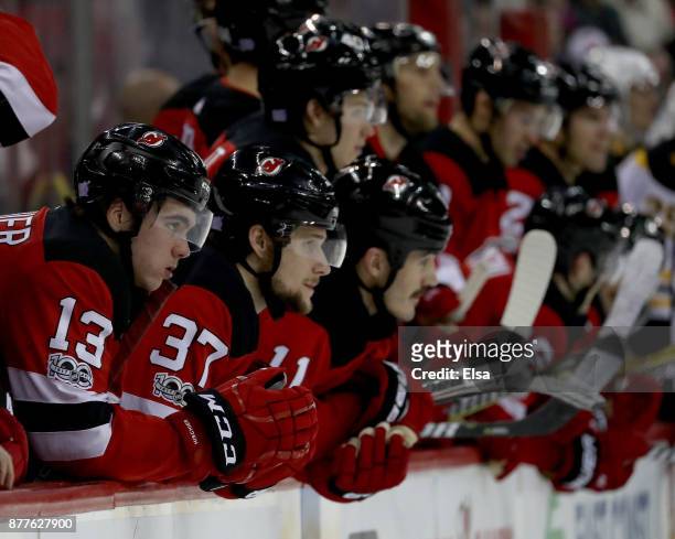 Nico Hischier and Pavel Zacha of the New Jersey Devils watch the shootout with the rest of their teammates on November 22, 2017 at Prudential Center...