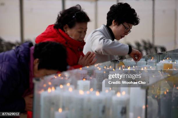 South Korean pray for their family's success in the annual college entrance examination during a special prayer service at Chogye Buddhist temple on...