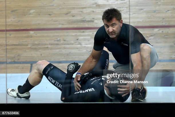 Zac Williams of New Zealand is comforted by New Zealand sprint coach Anthony Peden as he waits to receive treatment for an injury after a crash in...