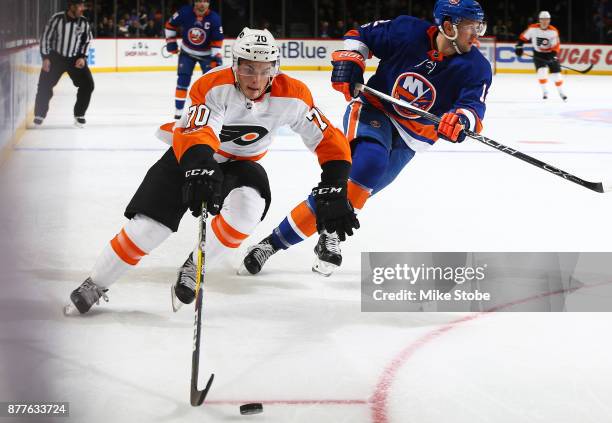 Danick Martel of the Philadelphia Flyers plays the puck against Josh Bailey of the New York Islanders in his first NHL game at Barclays Center on...