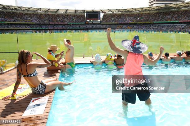 Fans cool off in the pool at the Gabba Pool Deck during day one of the First Test Match of the 2017/18 Ashes Series between Australia and England at...