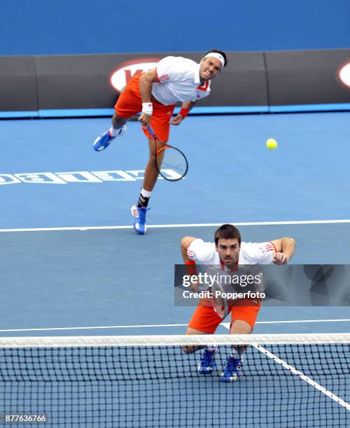 Ross Hutchins serves while Colin Fleming of Great Britain waits in a Men's doubles 2nd round match against Alex Bogomolov, Jr. And Igor Kunitsyn of...