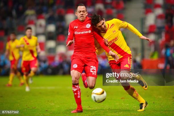 Rodrigo Salinas of Toluca and Diego Valdes of Morelia fight for the ball during the quarter finals first leg match between Toluca and Morelia as part...