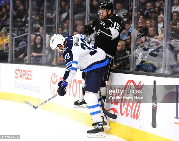 Andy Andreoff of the Los Angeles Kings takes a check from Dustin Byfuglien of the Winnipeg Jets during the second period at Staples Center on...