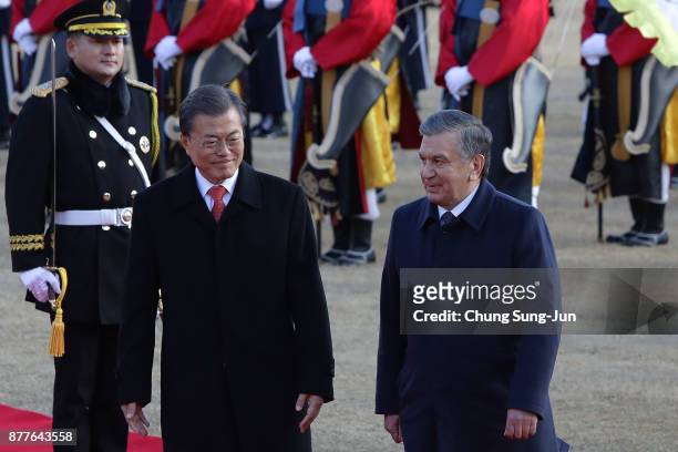 South Korean President Moon Jae-In and Uzbekistan President Shavkat Mirziyoyev walk towards a guard of honour during a welcoming ceremony at the...