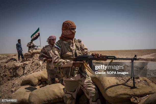Soldiers of Quwat al Nukhba overlooks an ISIS village and prepare for a possible suicide car with Rocket Propelled grenades, PKM machine gun and...