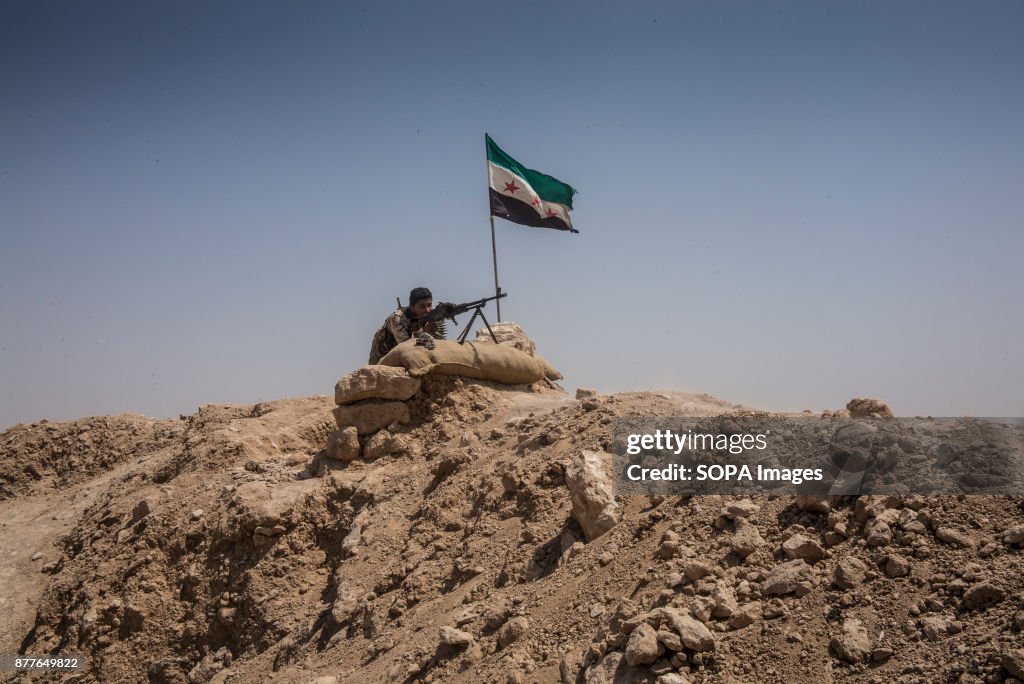 A soldier from Quwat Al Nukhba opens fire towards a Islamic...