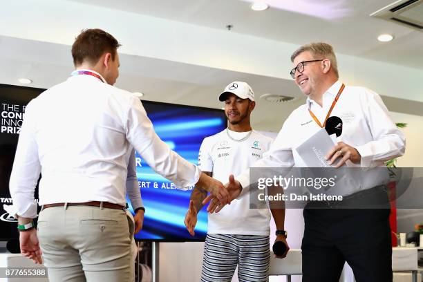 Ross Brawn, Managing Director of the Formula One Group and Lewis Hamilton of Great Britain and Mercedes GP congratulate the winners Benjamin Lambert...