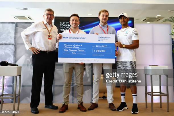 Benjamin Lambert and Alexander Gibson are presented with the Grand Prize by Ross Brawn, Managing Director of the Formula One Group, Lewis Hamilton of...