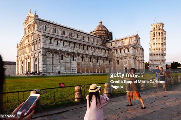 Tourists taking photos of the Cathedral and Leaning Tower.