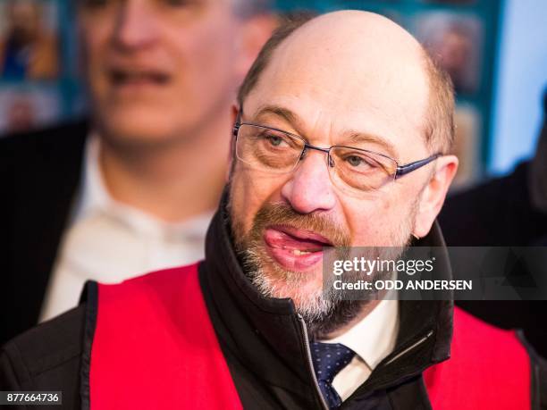 Leader Martin Schulz joins protesting Siemens workers from the IG Metal union who demonstrate outside the Estrel hotel in Berlin on November 23,...