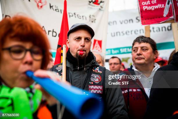 Protesting Siemens workers from the IG Metal union are seen demonstrating outside the Estrel hotel in Berlin on November 23, 2017. German industrial...