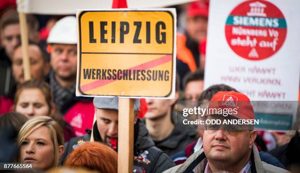 Protesting Siemens workers from the IG Metal union are seen demonstrating outside the Estrel hotel in Berlin on November 23, 2017. German industrial...