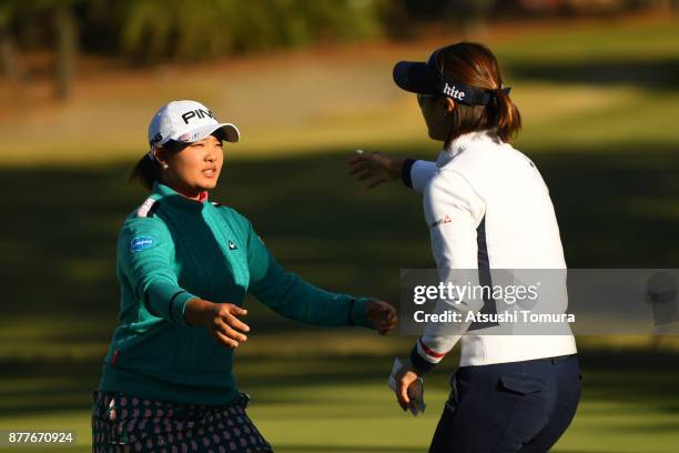 Ai Suzuki of Japan and Ha-Neul Kim of South Korea hag during the first round of the LPGA Tour Championship Ricoh Cup 2017 at the Miyazaki Country...