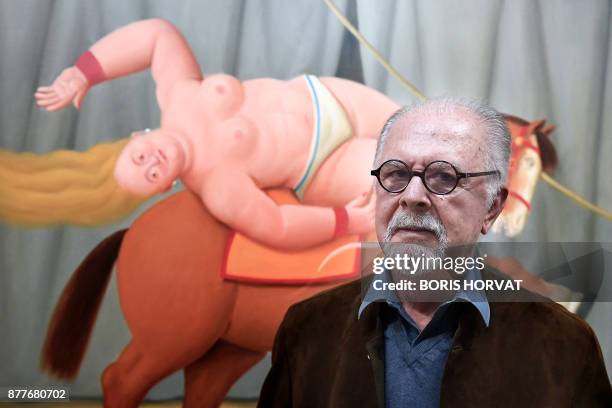 Colombian artist Fernando Botero poses on November 22, 2017 in front of one of his painting displayed at the Hotel de Caumont, in Aix en Provence,...