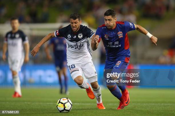 Dimitri Petratos of the jets contests the ball with Matias Sanchez of the Victory during the round eight A-League match between the Newcastle Jets...