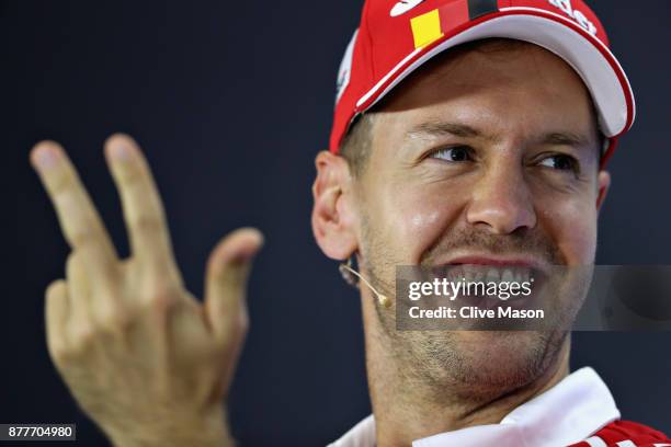 Sebastian Vettel of Germany and Ferrari counts on his fingers in the Drivers Press Conference during previews for the Abu Dhabi Formula One Grand...