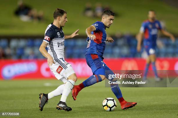 Dimitri Petratos of the Jets is contested by James Troisi of the Victory during the round eight A-League match between the Newcastle Jets and the...