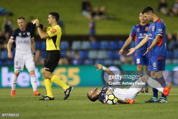 Referee Stephen Lucas issues a yellow card to Matias Sanchez of the Victory for faking injury during the round eight A-League match between the...