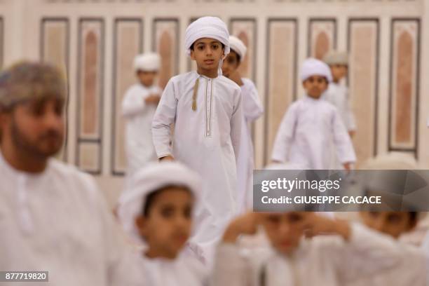 Children attend a group prayer on October 31, 2017 at Muscat's Sayyida Mazoon mosque in the Gulf sultanate of Oman. - Oman -- home to Sunnis, Shiites...