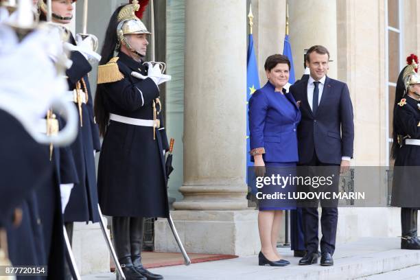 French President Emmanuel Macron welcomes Polish Prime Minister Beata Szydlo before a meeting at the Elysee Palace in Paris on November 23, 2017.