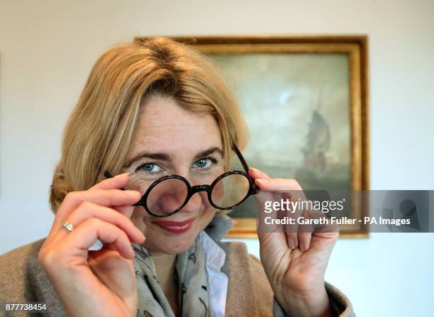 Auctioneer Catherine Southon at Bromley Arts Centre in Bromley, Kent, with a pair of tortoiseshell spectacles made for Winston Churchill by C. W....