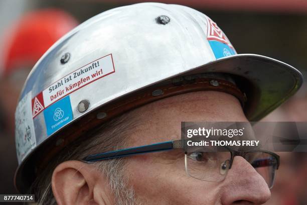 Worker of German heavy industry giant ThyssenKrupp wears a hard hat with a sticker reading " Steel is future, that is what we are fighting for" on...