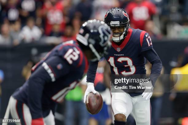 Braxton Miller of the Houston Texans runs to hand the ball to Bruce Ellington during an end zone celebration in the first half against the Arizona...