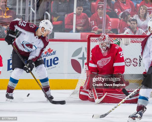 Jimmy Howard of the Detroit Red Wings makes a save as Colin Wilson of the Colorado Avalanche looks for the rebound during an NHL game at Little...