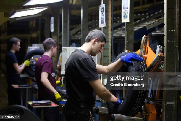 Workers inspect automobile tires at the Continental AG tire plant in Kaluga, Russia, on Wednesday, Nov. 22, 2017. The strong outlook for automated...