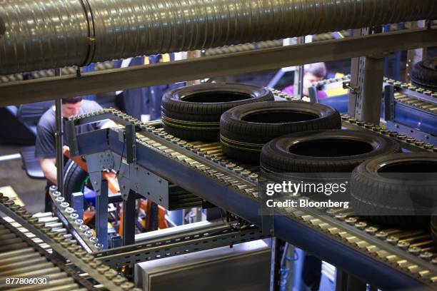 Automobile tires pass along a conveyor belt before a manual inspection at the Continental AG tire plant in Kaluga, Russia, on Wednesday, Nov. 22,...