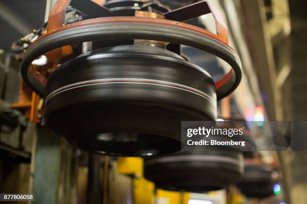 Machines move 'green' automobile tires before vulcanization at the Continental AG tire plant in Kaluga, Russia, on Wednesday, Nov. 22, 2017. The...
