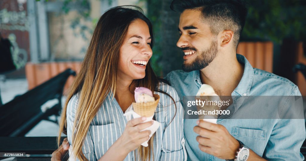 Happy couple having date and eating ice cream