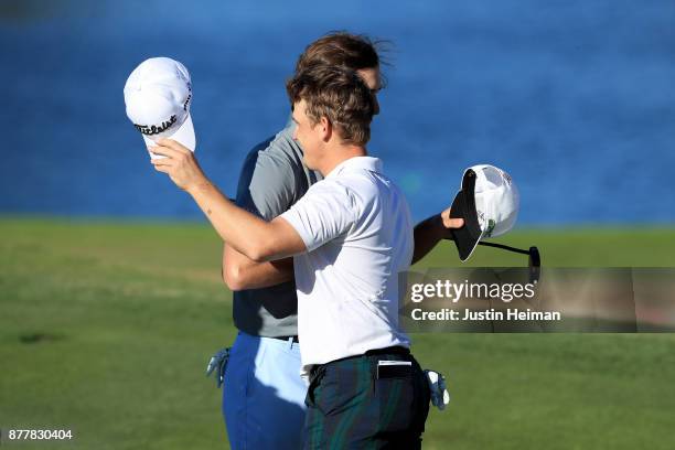 Bud Cauley of the United States shakes hands with Kelly Kraft of the United States on the 18th green during the final round of The RSM Classic at Sea...