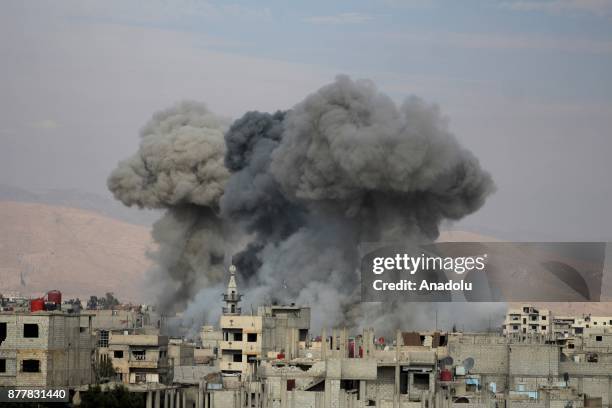 Smoke rises after Assad regime's warcrafts carried out airstrikes over Arbin of the Eastern Ghouta region of Damascus in Syria on November 23, 2017.