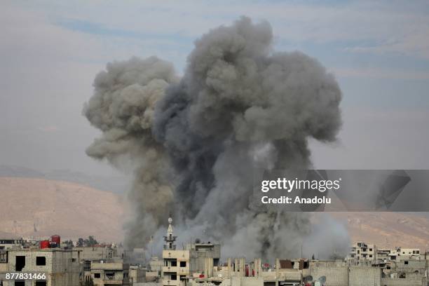 Smoke rises after Assad regime's warcrafts carried out airstrikes over Arbin of the Eastern Ghouta region of Damascus in Syria on November 23, 2017.