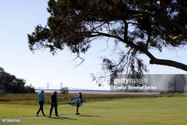 Aaron Wise and Zach Johnson of the United States walk up the fairway on the 13th hole during the final round of The RSM Classic at Sea Island Golf...