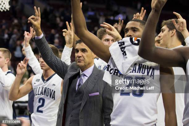 Collin Gillespie, head coach Jay Wright, and Mikal Bridges of the Villanova Wildcats celebrate at the end of the game against the Columbia Lions at...