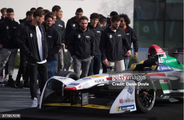 Real Madrid CF players look at the Audi e racing car during the presentation of their new Audi cars as part of an ongoing sponsorship deal with Real...