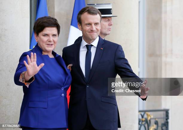 French President Emmanuel Macron welcomes Polish Prime Minister Beata Szydlo prior to their meeting at the Elysee Presidential Palace on November 23,...