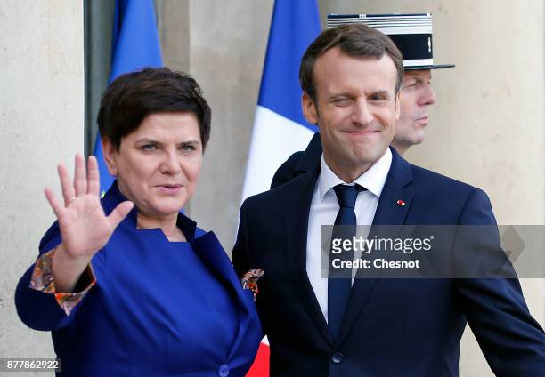 French President Emmanuel Macron welcomes Polish Prime Minister Beata Szydlo prior to their meeting at the Elysee Presidential Palace on November 23,...