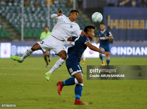 Chennaiyin FC Jeje Lalpekhlua vies for the ball with NorthEast United FC's Abdul Hakku during the Indian Super League football league match between...